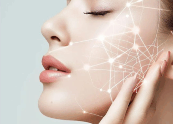 Close-up of a woman with glowing, smooth skin and digital light network graphics on her face representing collagen and skin rejuvenation.
